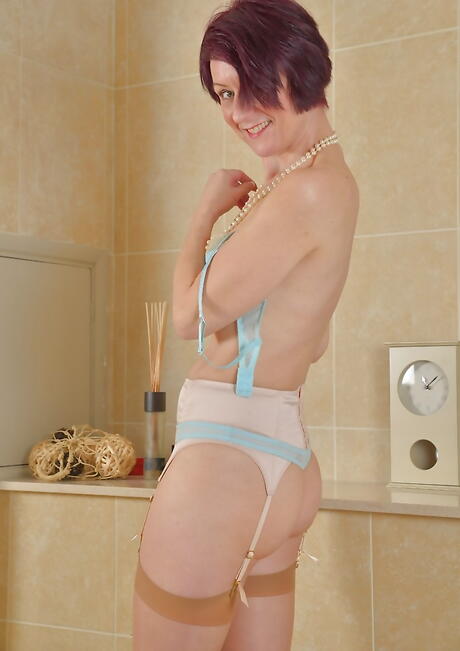 Sexy british aged Penny Brooks in hot lingerie exhibits small tits and spreads her legs in bathroom